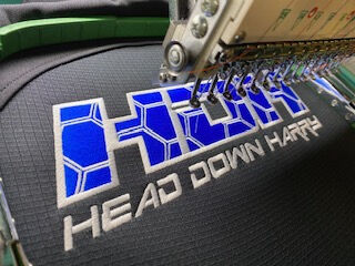 Team wearing embroidered workwear uniforms with company logos