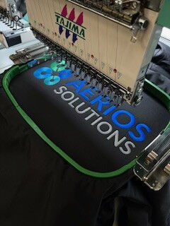 Close-up of embroidered company logo on polo shirt